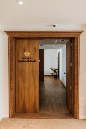 a wooden door with a sign that reads new alhambra at Hotel Nais in Niš