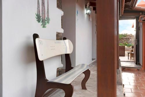 a wooden bench sitting next to a wall at Finca Los Angeles in San Juan de la Rambla