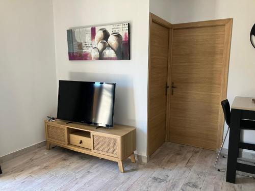 a flat screen tv sitting on a stand in a room at studio rocca in Sotta