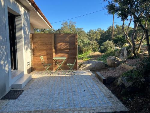 a patio with a table and chairs next to a building at studio rocca in Sotta