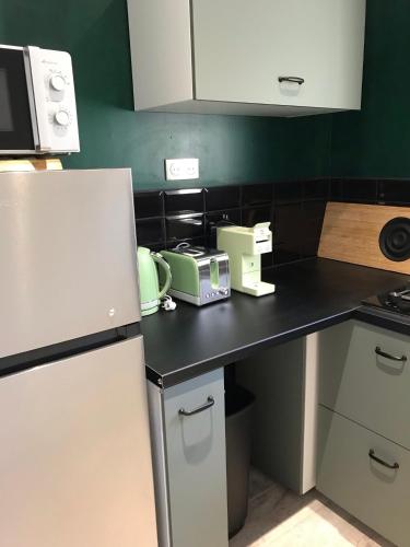 a kitchen with a black counter with appliances on it at studio rocca in Sotta