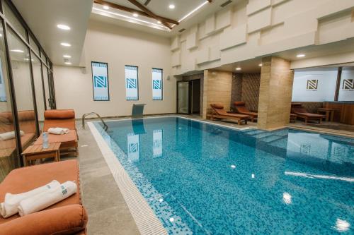 a large swimming pool in a hotel room at Hotel Nais in Niš
