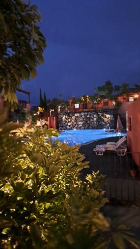 a view of a swimming pool at night at Aparthotel El Cerrito in Los Cancajos