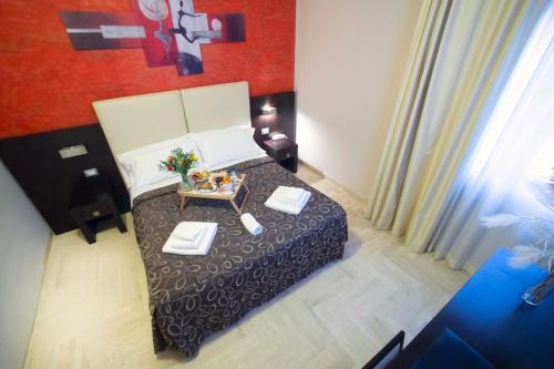 a small bedroom with a bed and a table at Albergo Cantiani in Ancona