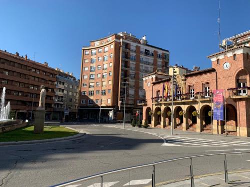 an empty street in a city with tall buildings at Calahorra Centro in Calahorra