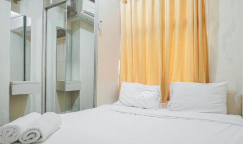 a bedroom with a bed with towels on it at Apartment pancoran in Jakarta