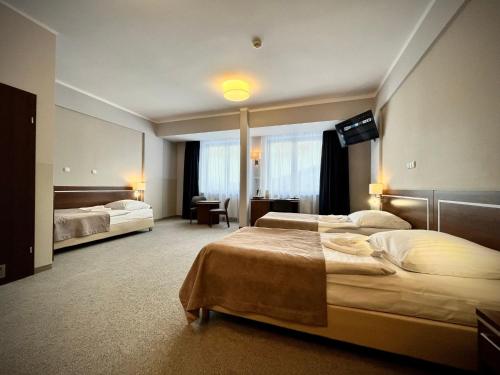 Postel nebo postele na pokoji v ubytování Hotel Szyndzielnia