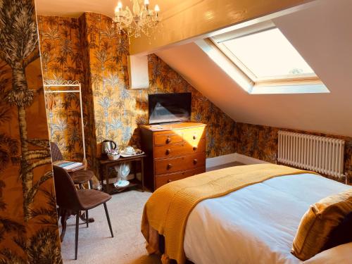 a bedroom with a bed and a skylight at The Old Registry guest house in Haworth