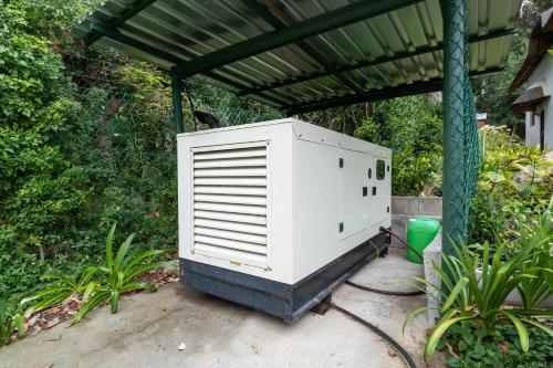 a large white appliance sitting under a roof at Plotsklaps Self Catering Cottage in Tokai