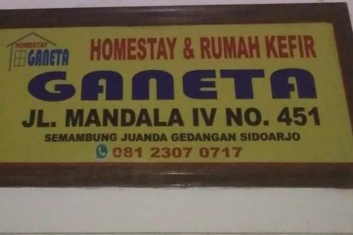 a sign on a wall that reads homeopathy andryu kumar gaetena at Ganeta Homestay Syariah in Kalangan