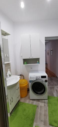 a kitchen with a washing machine and a sink at Center Haus in Bucharest