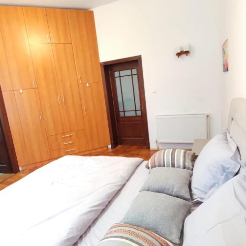 a large white bed in a room with a wooden door at Center Haus in Bucharest
