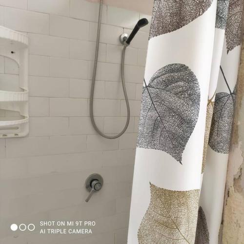 a shower curtain with a butterfly on it in a bathroom at Casa Cappero in Noto Marina