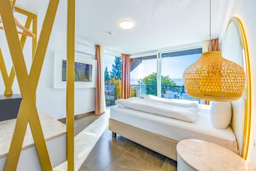 a bedroom with two beds and a large window at Vila Bisera in Ohrid