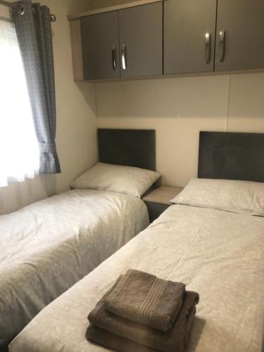 a room with two beds and a window at Cumbria Reach in Longtown