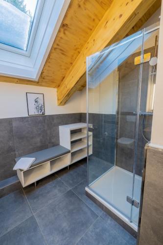a bathroom with a shower and a glass enclosure at Hillside Chalet Kreischberg in Sankt Lorenzen ob Murau