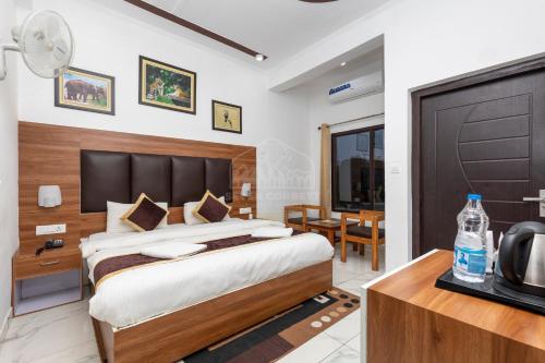 a hotel room with a bed and a television at Seven Corbett in Rāmnagar