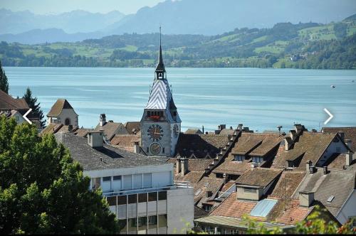 a view of a town with a clock tower at Studio flat in the heart of Zug, ideal for solo travellers in Zug