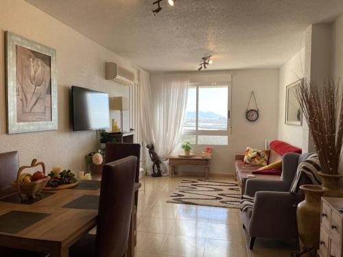 a living room with a table and a couch at Casa Luna - Sea view apartment Bolnuevo in Bolnuevo