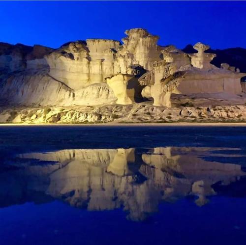 a reflection of a mountain in the water at Casa Luna - Sea view apartment Bolnuevo in Bolnuevo