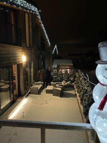 a person walking down a snow covered street at night at Apartments Pemikas I in Liptovský Mikuláš