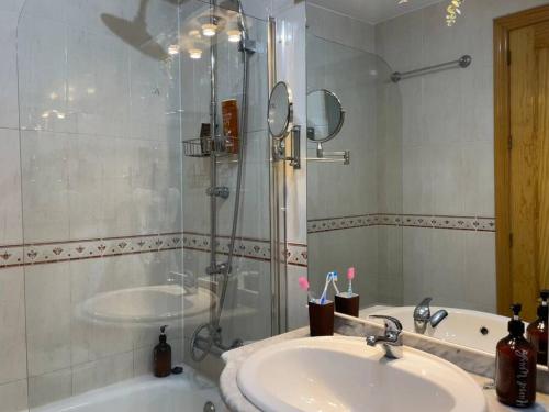 a bathroom with a sink and a shower at Casa Luna - Sea view apartment Bolnuevo in Bolnuevo