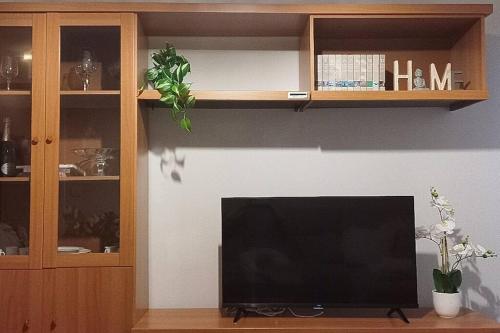 a flat screen tv sitting in a living room at Renovated apartment, center and hospital in Udine