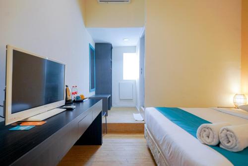 Ένα ή περισσότερα κρεβάτια σε δωμάτιο στο Sans Sunset Point Seminyak