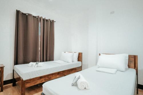 Postel nebo postele na pokoji v ubytování Sonora's Inn, Coron