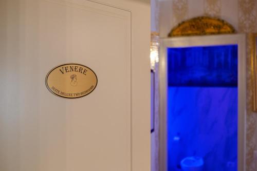 a sign on a wall next to a door at Royal Olympus Verona in Verona