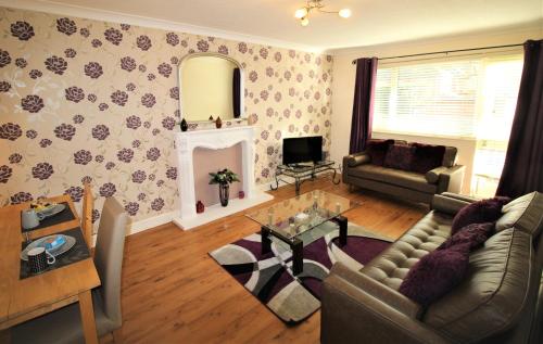 a living room with a couch and a table at Large Balcony Apartment - 2 Double Beds - Sleeps 4 - Close to Town & Racecourse - Off Street Parking 2 Cars - Fast Wifi in Doncaster