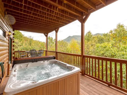 a hot tub on the deck of a cabin at A Majestic View III in Townsend