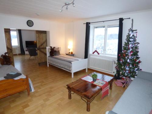 a living room with a christmas tree in a room at The Friendly Moose in Övertorneå