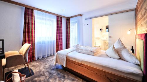 Postel nebo postele na pokoji v ubytování Hotel Garni Stefanie
