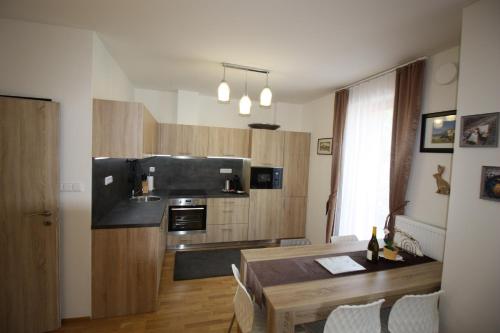 a kitchen with a table and a dining room at Apartmany Rezidence Klostermann & Javor & Skalka in Železná Ruda