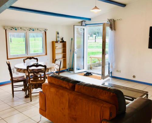 a living room with a couch and a table at Gîte de l’écuyer in Eygurande-et-Gardedeuil