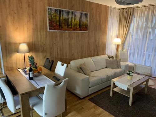 a living room with a couch and a table at Apartmany Rezidence Klostermann & Javor & Skalka in Železná Ruda