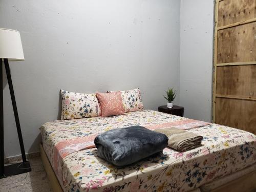 a bed with a pillow on it in a room at The Tea House in San Juan