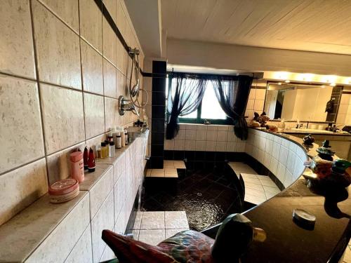 a bathroom with a tub in the middle of a room at Estate Tsiati - Κτήμα Τσιάτη in Nafplio