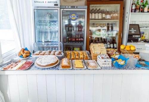 a bakery counter with different types of bread and pastries at Hotel & Spa Relais Freedom Club in Massa Lubrense