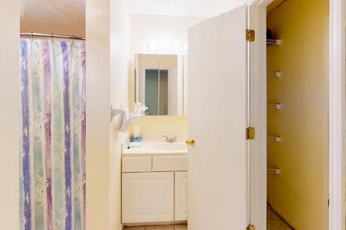 a bathroom with a sink and a mirror at Gulf Terrace 126 in Destin