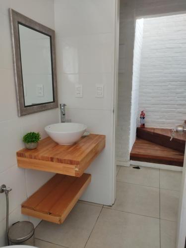 a bathroom with a white sink and a mirror at Serena Aparts in La Paloma