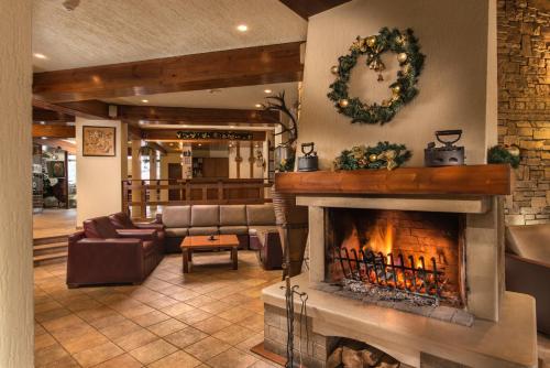 a living room with a fireplace and a couch at Hotel Pirin in Bansko