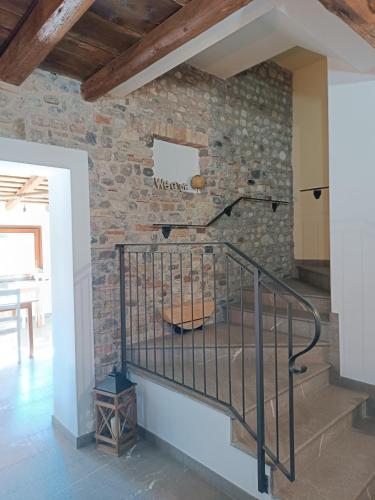a staircase in a room with a stone wall at CASAL MICELIO in Udine