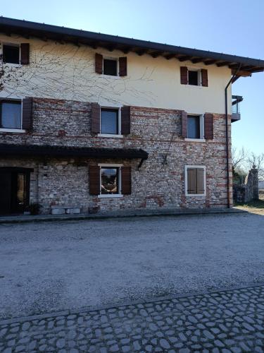 a brick building with windows on the side of it at CASAL MICELIO in Udine
