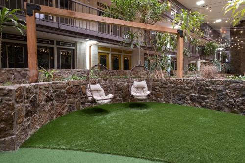 a artificial grass yard in front of a building at The Westerner - Extended Stay in Amarillo
