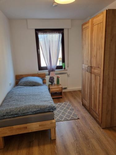 a bedroom with a bed and a large window at Ferienwohnung Irina in Zülpich