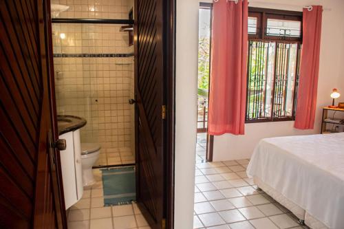 uma casa de banho com uma cama e uma casa de banho com um WC. em Apartamento a 400 metros da Praia do Frances-AL em Marechal Deodoro