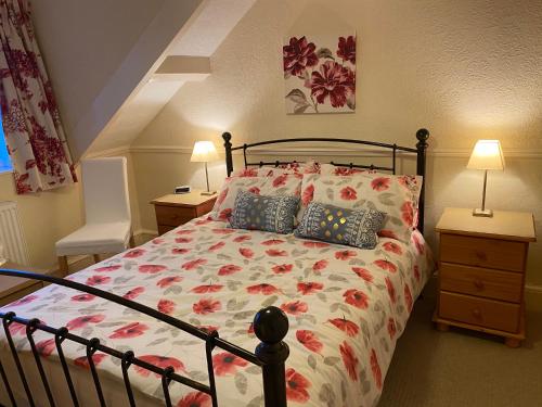 a bedroom with a bed with a floral bedspread at The Laurels in Blackpool
