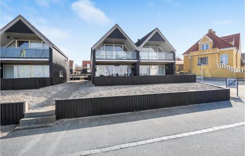 a house with a lot of windows on a driveway at Two-Bedroom Holiday Home In Tranekar in Lohals